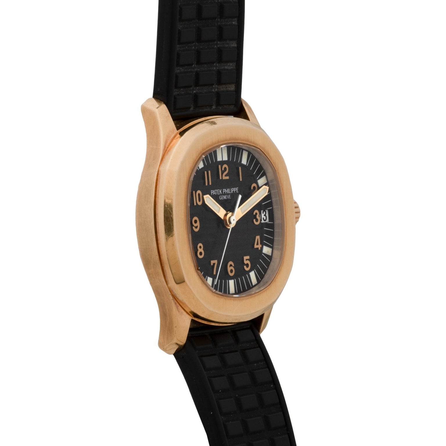A Patek Philippe Aquanaut wristwatch featuring a gold case, black dial with Arabic numerals, and a black rubber strap.
