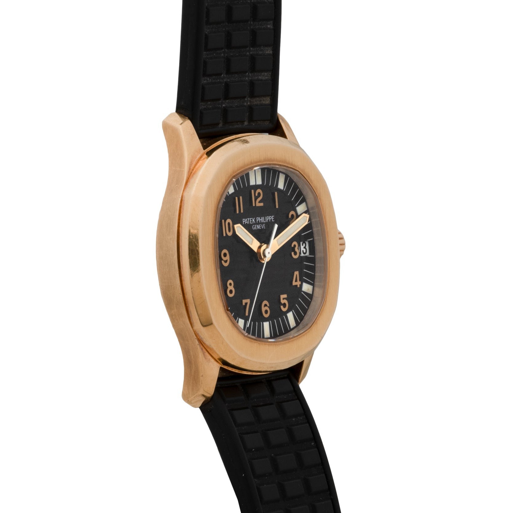 A Patek Philippe Aquanaut wristwatch featuring a gold case, black dial with Arabic numerals, and a black rubber strap.