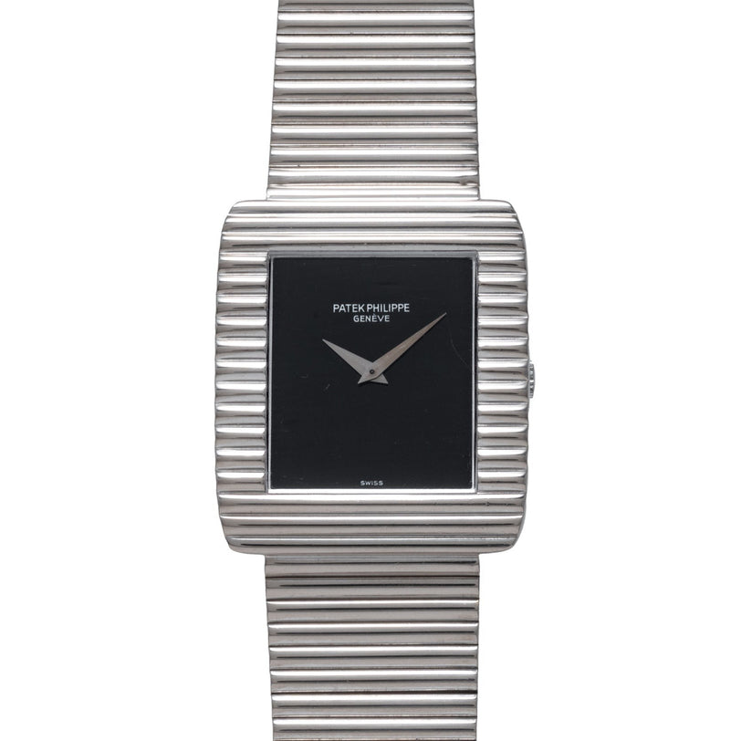 A Patek Philippe Ellipse Gondolo Onyx wristwatch featuring a silver ribbed band and a rectangular black dial.