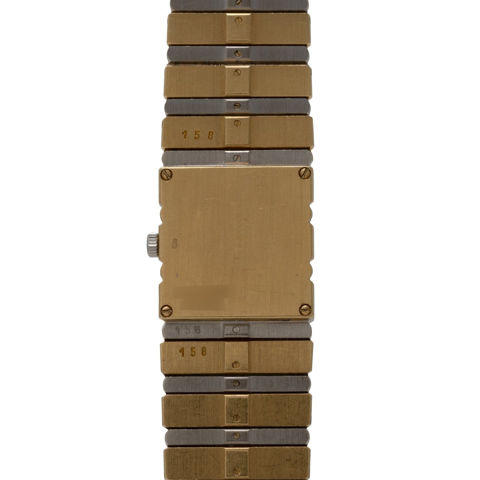 The Piaget Polo Pave is a rectangular gold and silver metal wristwatch featuring a plain face and segmented bracelet.
