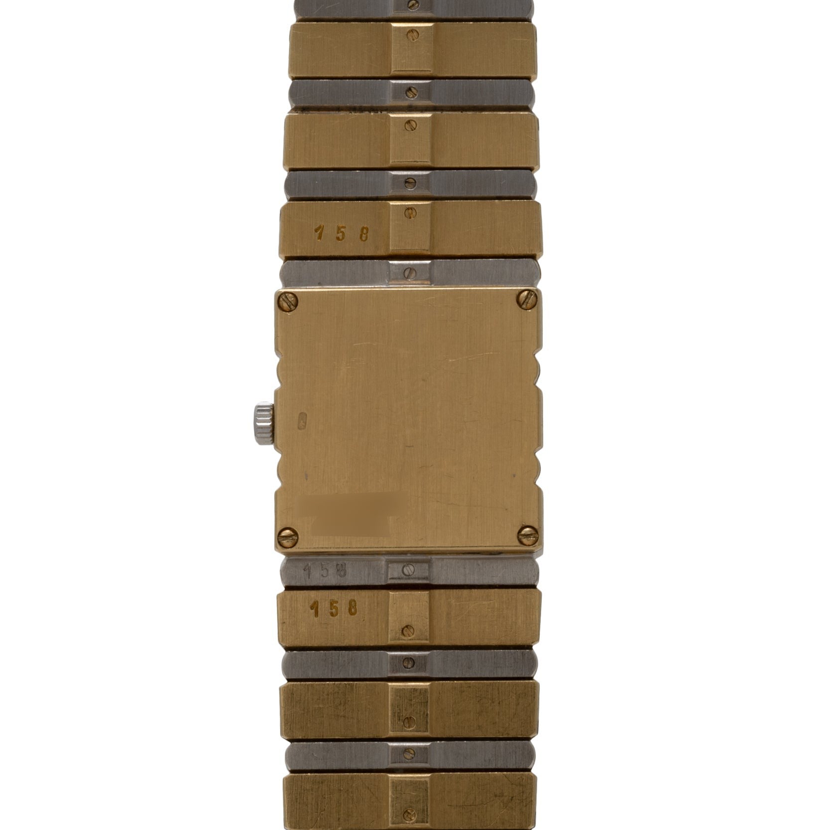 The Piaget Polo Pave is a rectangular gold and silver metal wristwatch featuring a plain face and segmented bracelet.