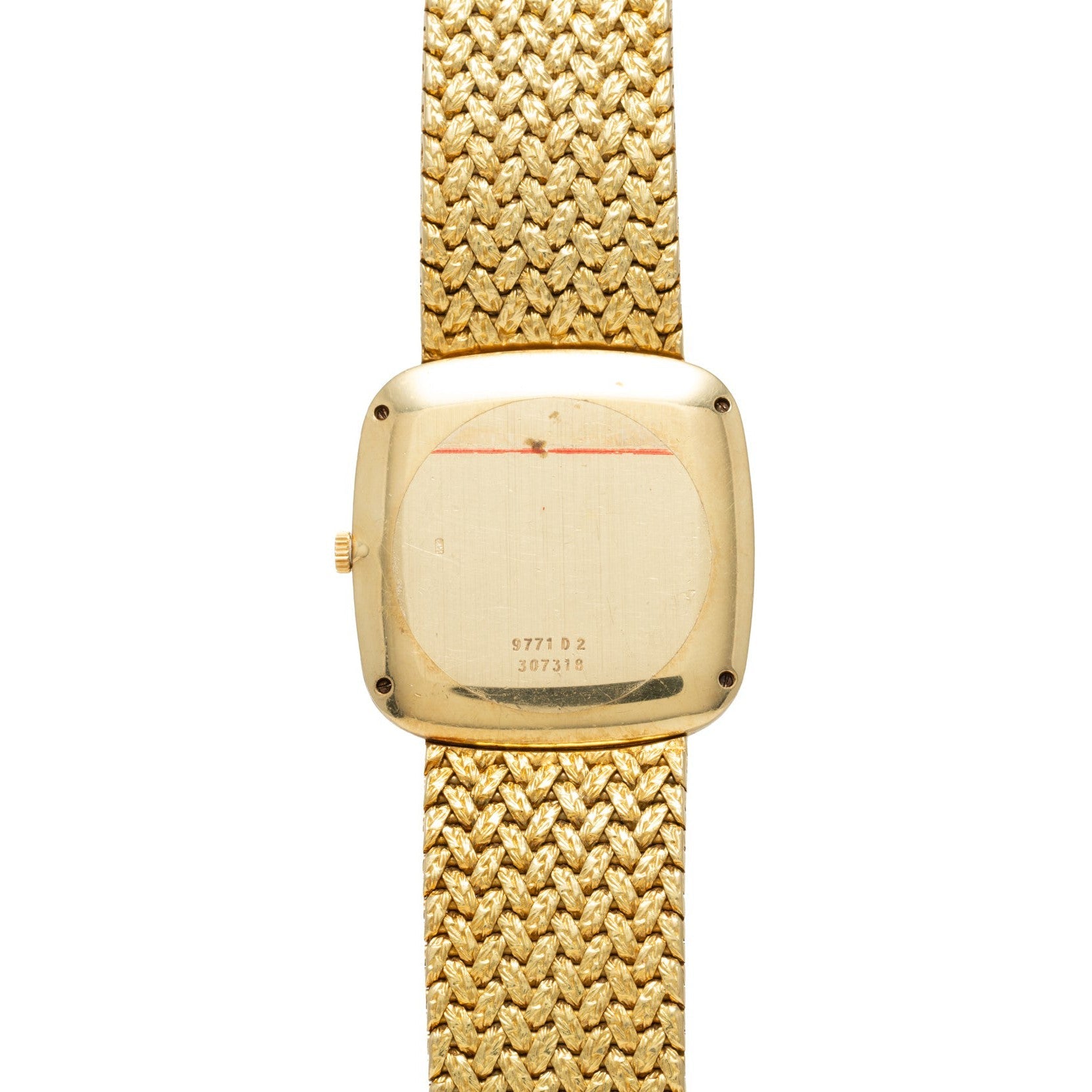 The Piaget Pave Lapis Lazuli Dress Watch is shown from the back, featuring a textured gold band and visible serial numbers on the case.