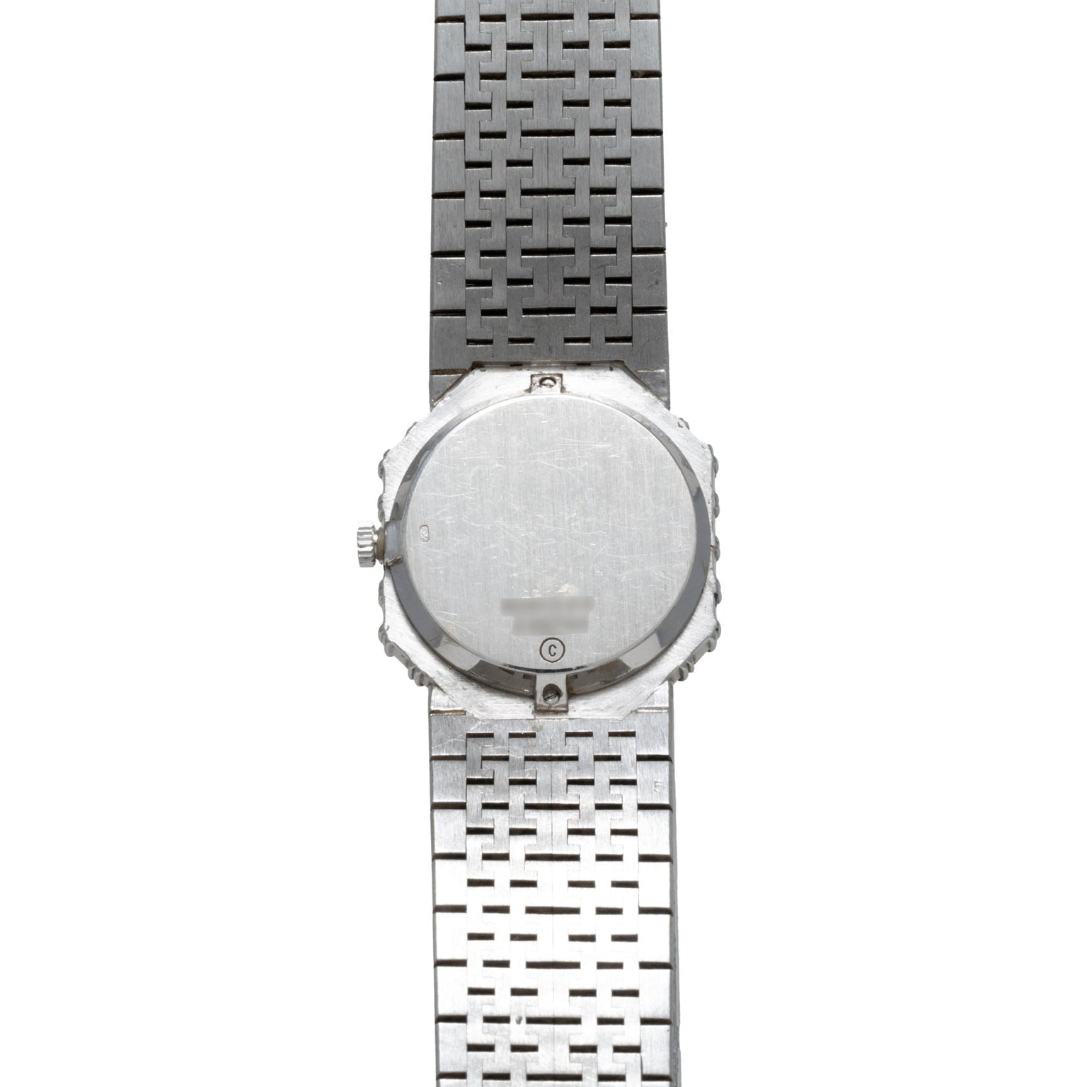 The back of the Piaget Opal White Gold Dress Watch with a metal link band is shown vertically against a white background.