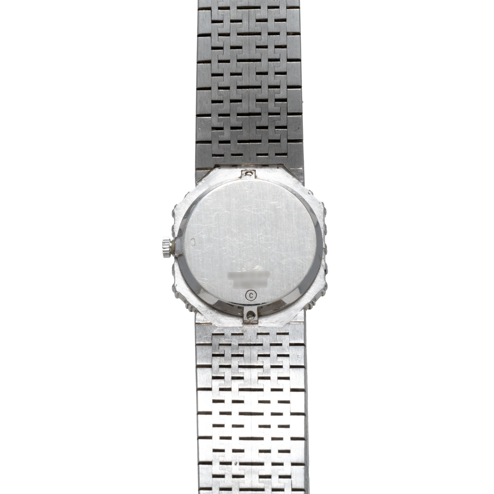 The back of the Piaget Opal White Gold Dress Watch with a metal link band is shown vertically against a white background.