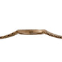 Side view of the Patek Philippe Calatrava, a slim gold wristwatch featuring a textured bracelet and a round crown.