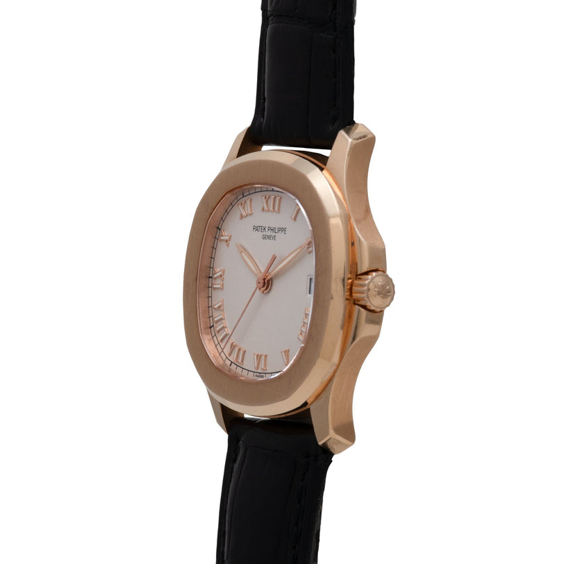 Rose gold Patek Philippe Aquanaut wristwatch featuring a white dial, Roman numerals, and black leather strap, shown from an angled side view.