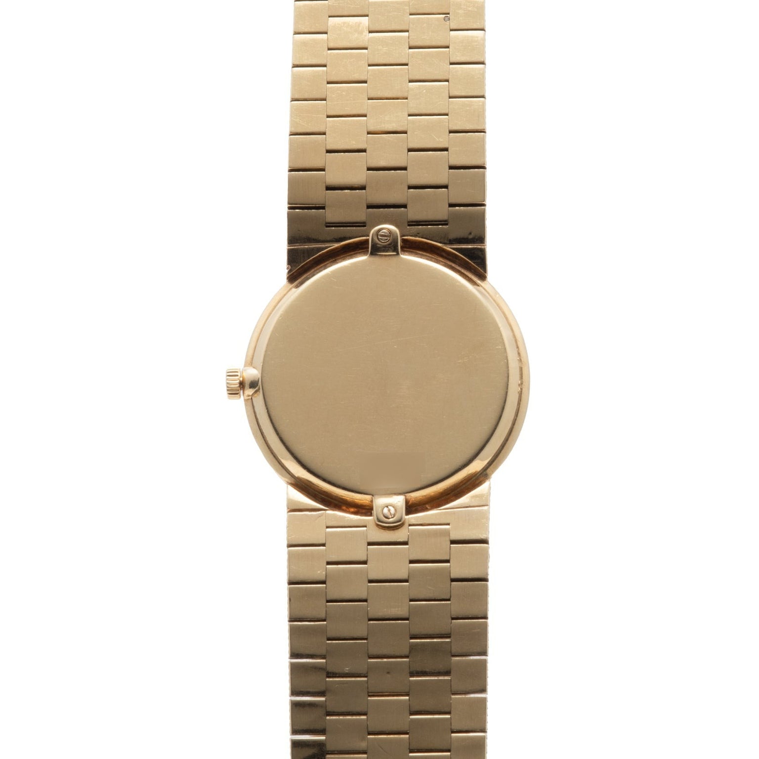 The Piaget 18K Yellow Gold Dress Watch features a blank round face and a linked bracelet band, shown from above.