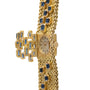 The Patek Philippe Yellow Gold Integrated Dress Watch features a textured band and blue gemstones set in a decorative bow design.