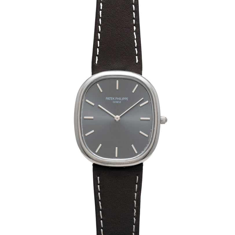 The Patek Philippe Ellipse features a gray dial, silver markers, and a black leather strap.
