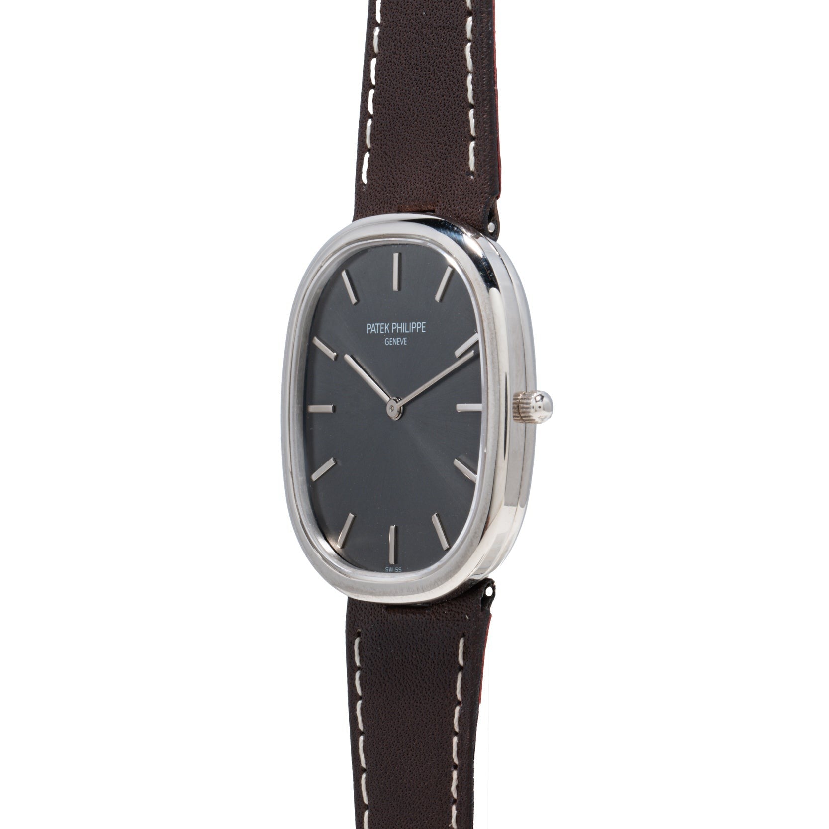 The Patek Philippe Ellipse is a sleek silver wristwatch featuring a dark face and a brown leather strap.