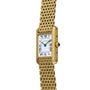 Cartier Tank Louis gold wristwatch featuring a rectangular face, Roman numerals, and a mesh bracelet shown upright.