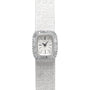 A luxurious Piaget White Gold Bark Diamond Dress Watch featuring a textured band and a diamond-encrusted rectangular face set to 10:09.