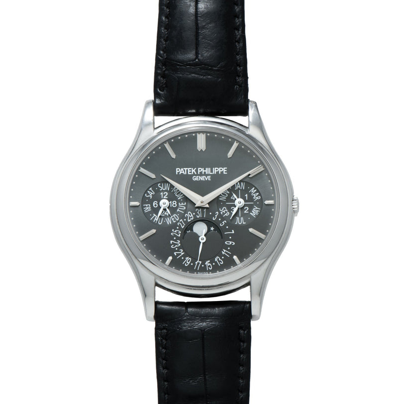 A Patek Philippe Perpetual Calendar wristwatch with a black leather strap and a black dial featuring multiple subdials.