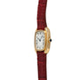 The Cartier Gondole Ladies watch features a gold rectangular case, white dial with Roman numerals, and a red leather strap, displayed at an angle.