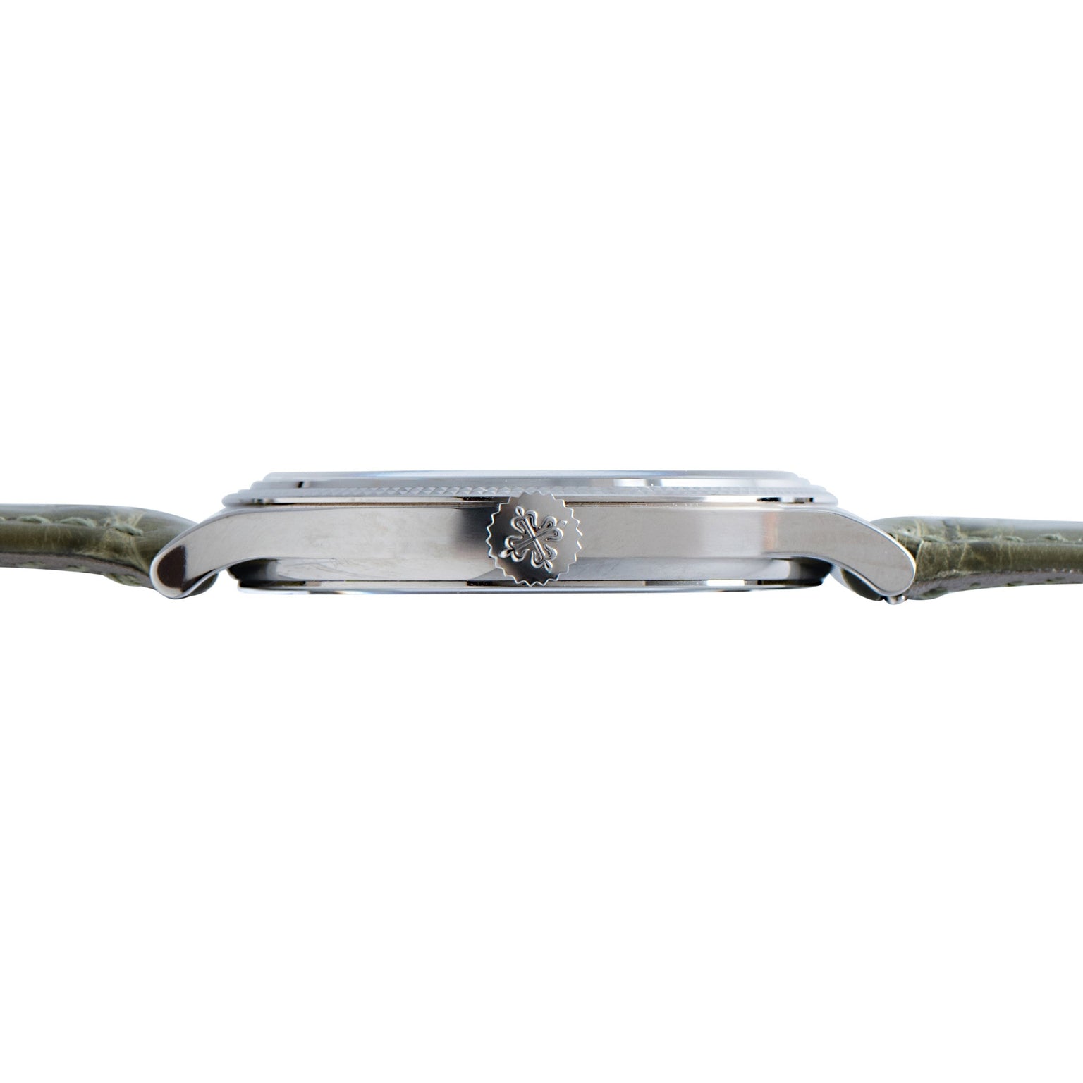 Side view of the Patek Philippe Calatrava Cloisonné Tropical Leaves II, a silver wristwatch with a green leather strap and decorative crown on the right side.