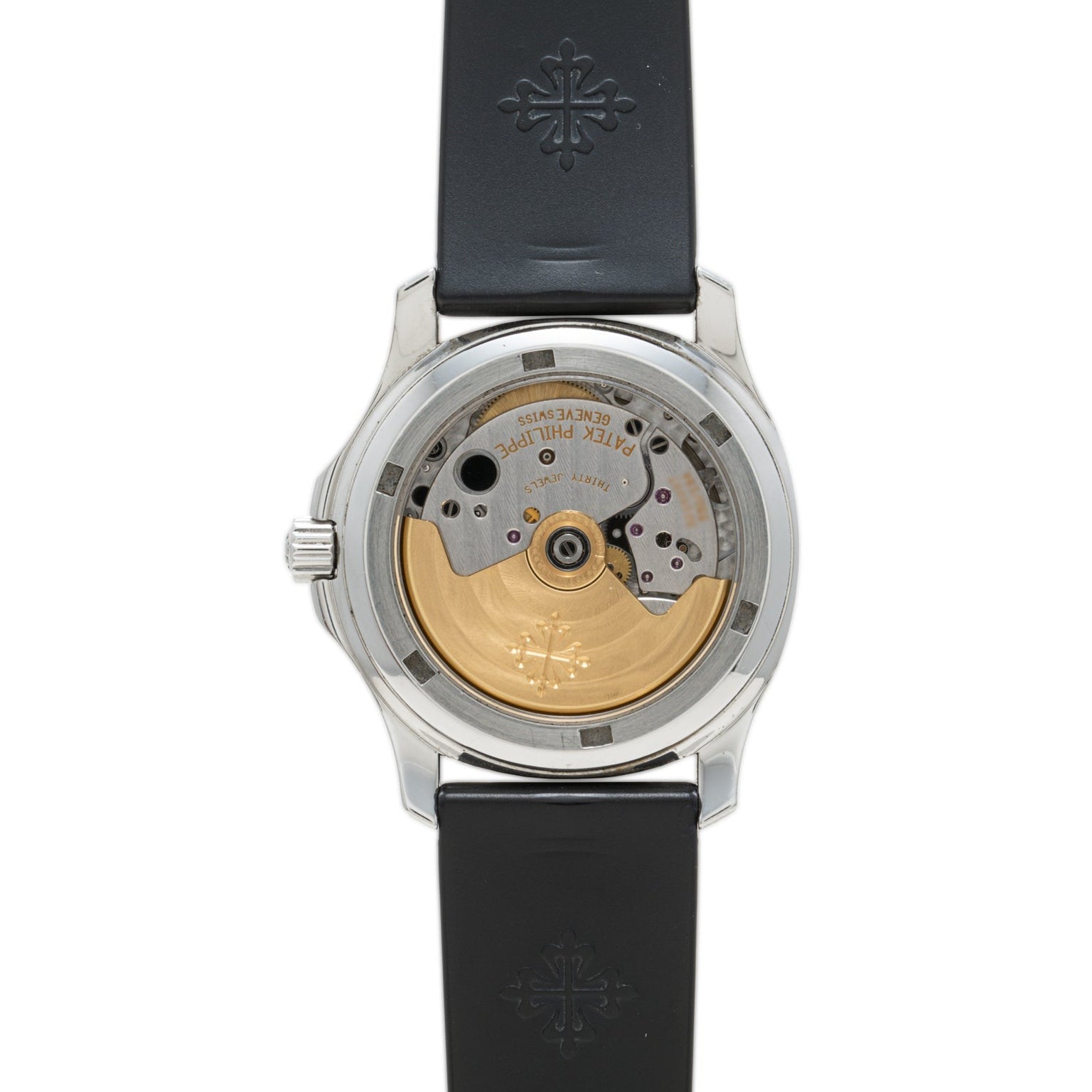 Back view of the Patek Philippe Aquanaut showing its gold rotor and mechanical movement, black strap, and engraved details.