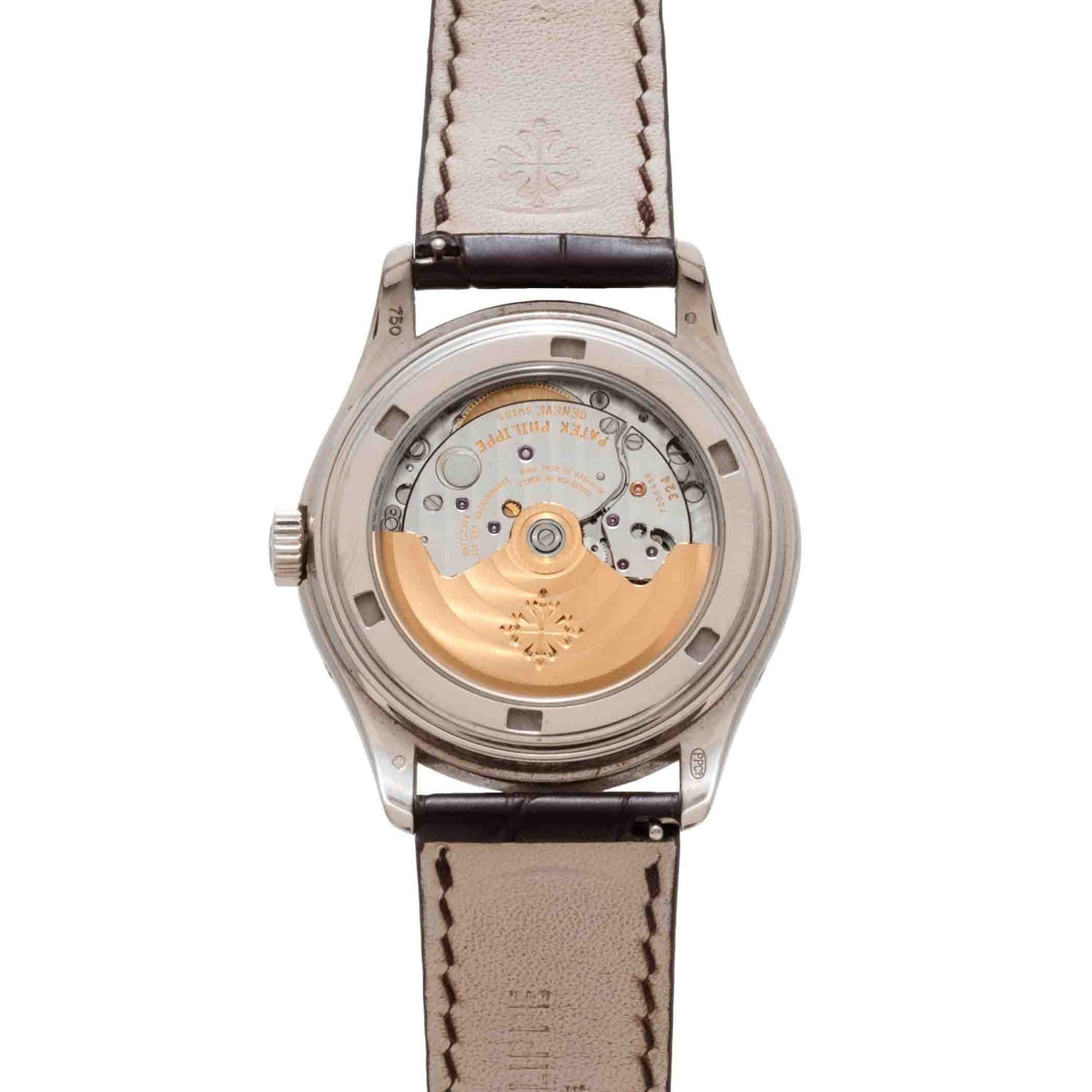 Back view of the Patek Philippe Annual Calendar Moonphase showcases its exposed mechanical movement with a gold rotor and leather strap.