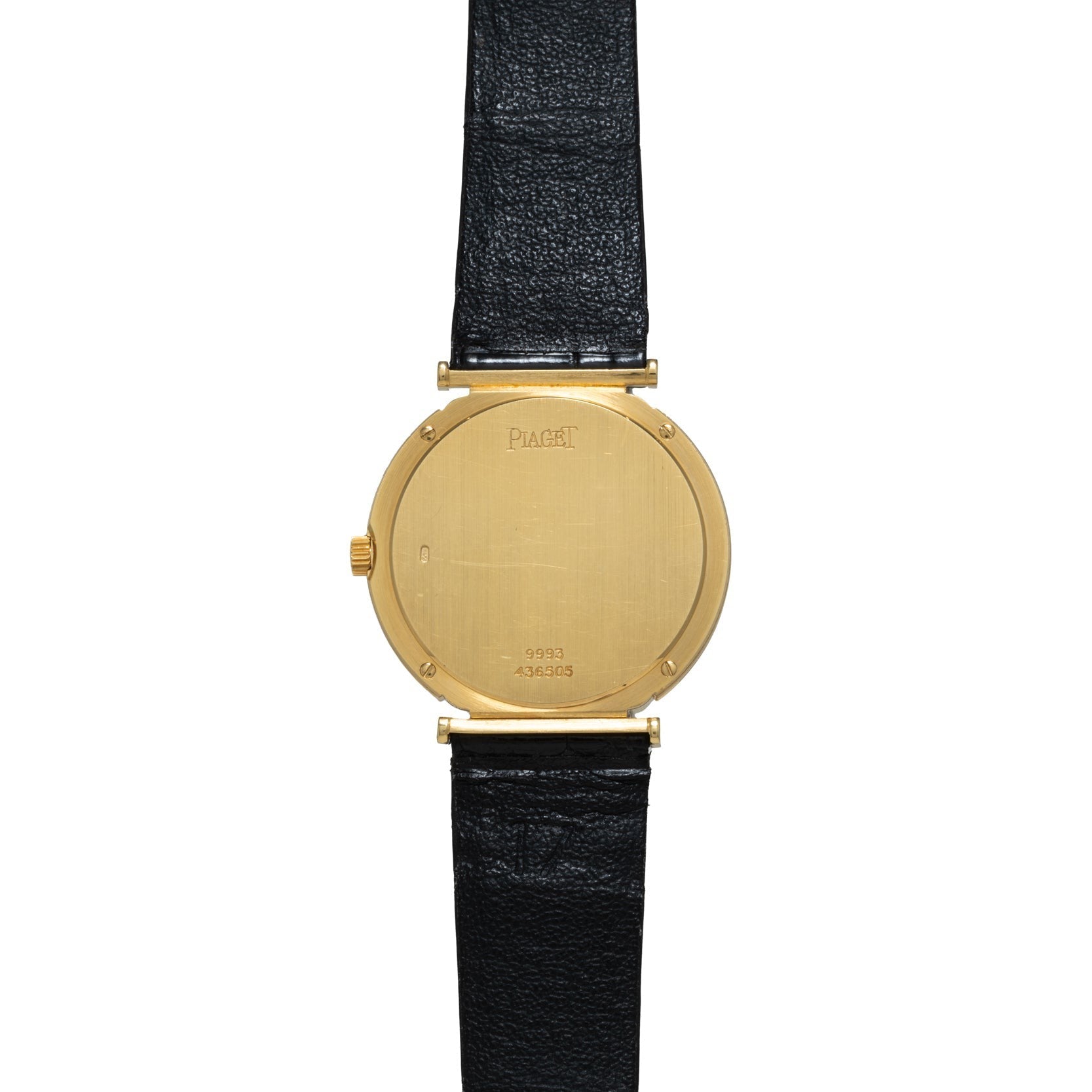 Piaget Polo Onyx gold watch with a black leather strap, displayed from the back showing visible serial numbers.