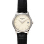 Patek Philippe Calatrava: silver wristwatch with black leather strap, cream dial, and date window at 3 o’clock.