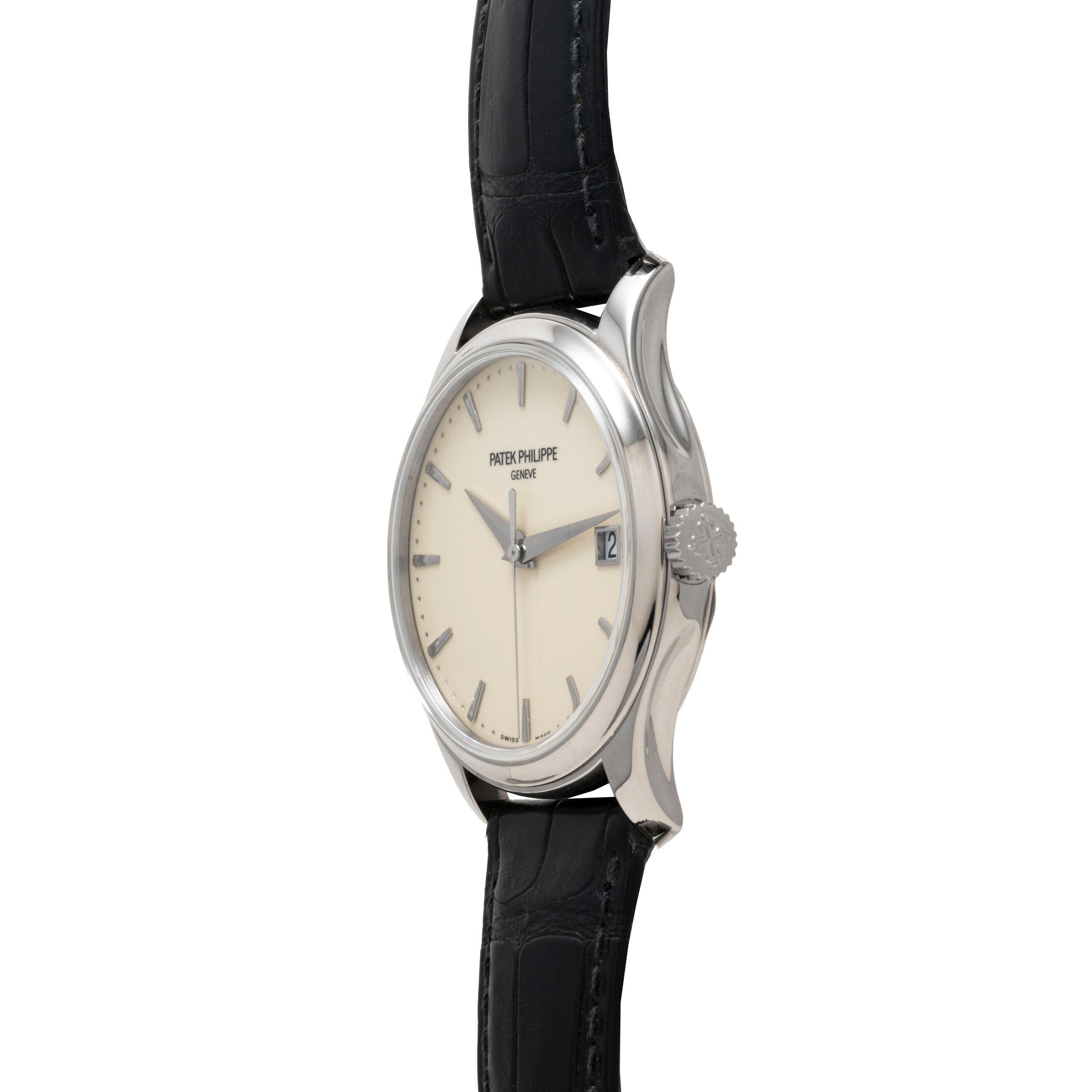 Side view of the Patek Philippe Calatrava wristwatch featuring a cream dial, date window, and black leather strap.