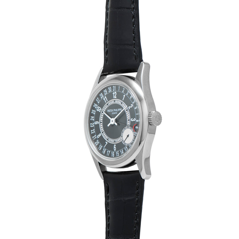 The Patek Philippe Calatrava is a silver wristwatch featuring a black leather strap and a circular date display.