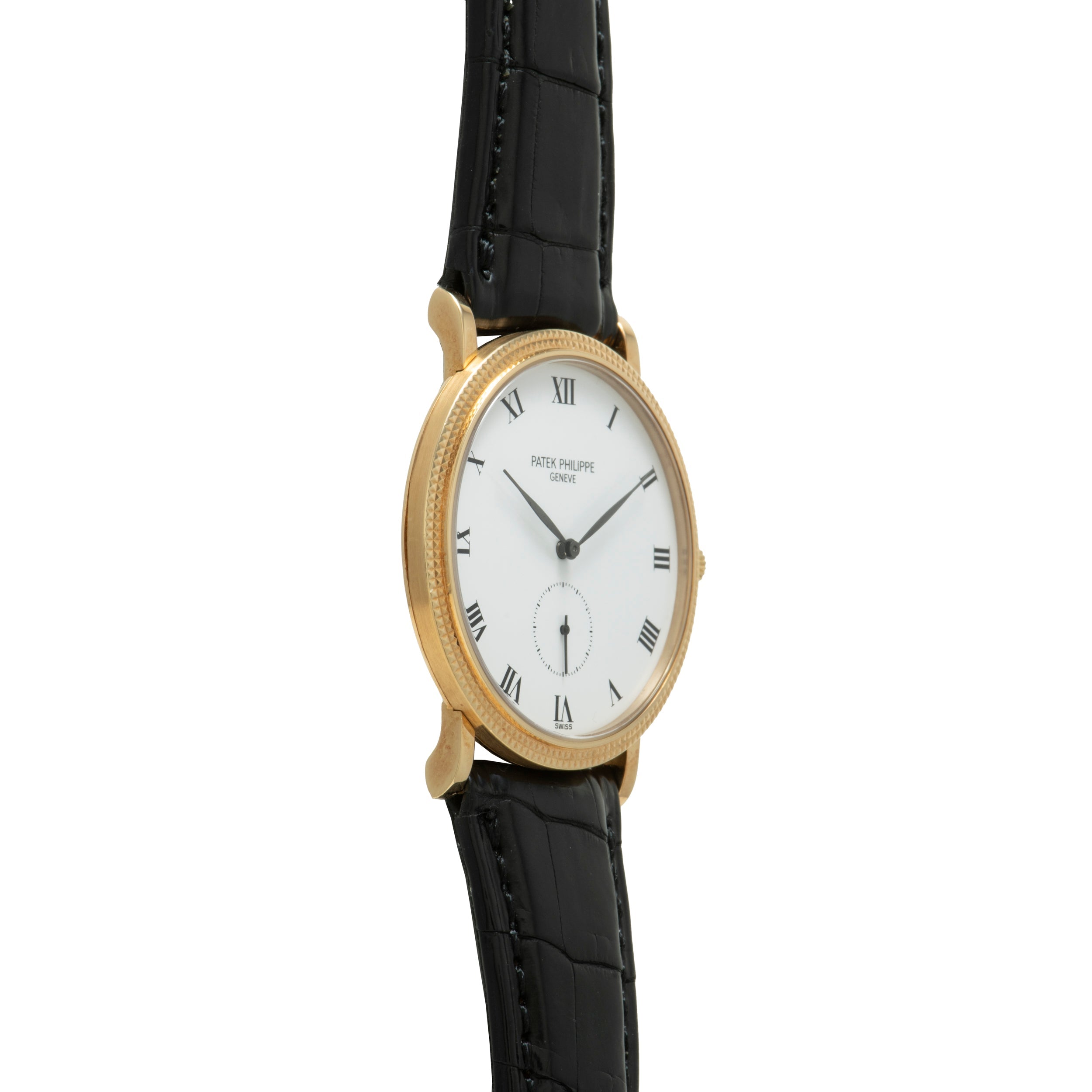 Patek Philippe Calatrava gold watch featuring a white dial with Roman numerals and a black leather strap, displayed at an angle.