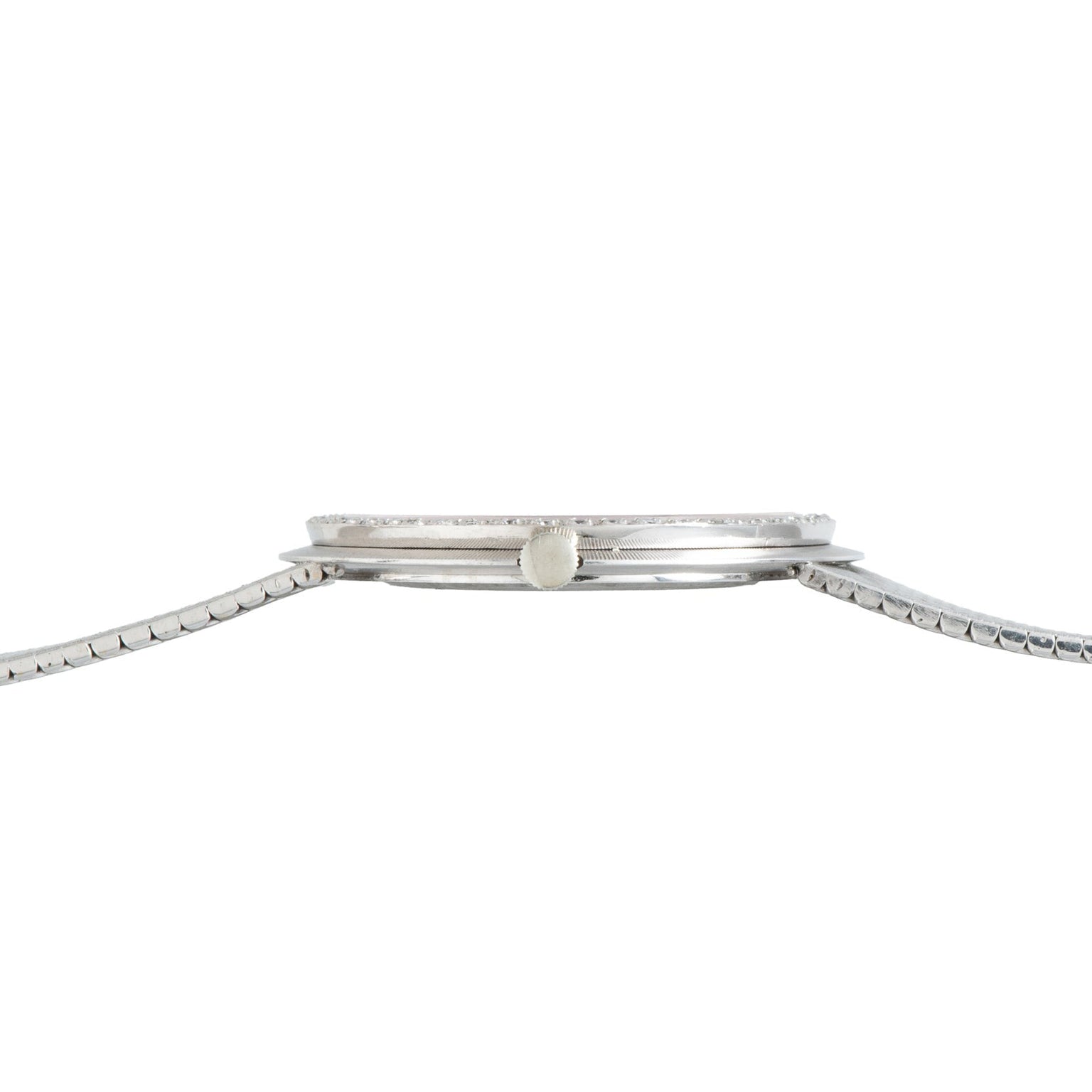 Side view of a thin Vacheron Constantin White Gold Diamond Bezel wristwatch with a metal band and a small crown.