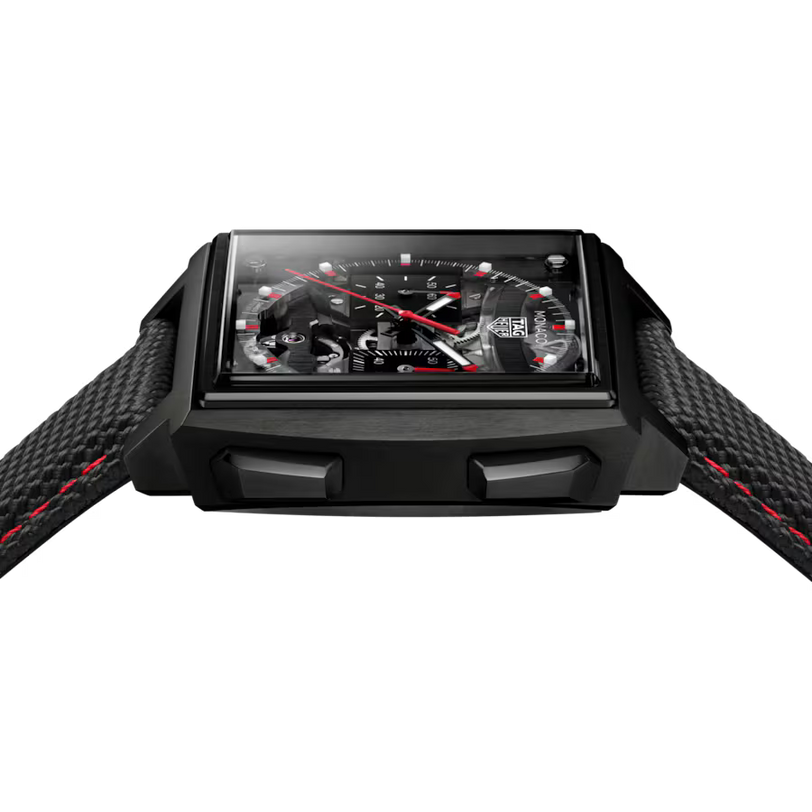 Black rectangular sports watch with red hands, black dial, red stitching on black rubber strap, displayed front-facing.