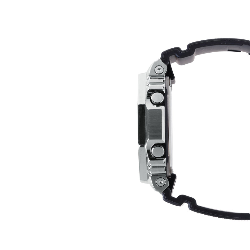 Digital watch with stainless steel and black resin case, shown from side profile with black band.