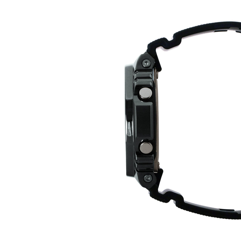 Black digital watch with stainless steel case, resin band, and multiple buttons on side profile.