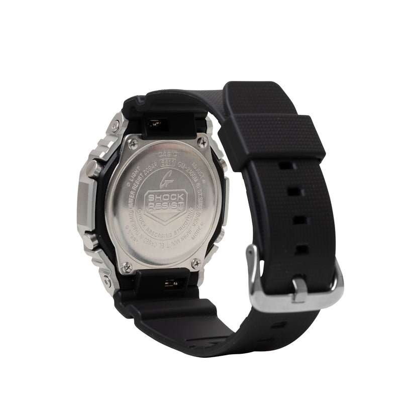 Silver stainless steel G-Shock watch with black resin band and silver buckle, shown from back case view.