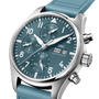 The IWC Schaffhausen Pilot Chronograph Miramar Edition features a teal dial, white numerals, three subdials, and a day-date display.