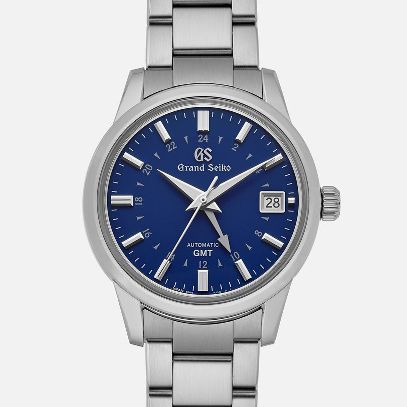 The Grand Seiko Automatic GMT SBGM239 Limited Edition For HODINKEE features a blue dial with silver markers and hands, date at 3 o’clock, GMT function, 24-hour inner ring, stainless steel case and bracelet. Available exclusively on HODINKEE.