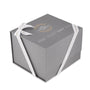 A gray square gift box with white ribbon, featuring gold and white text that reads The Watches of Switzerland Group—ideal for gifting the Breitling Navitimer B01 Chronograph 43.