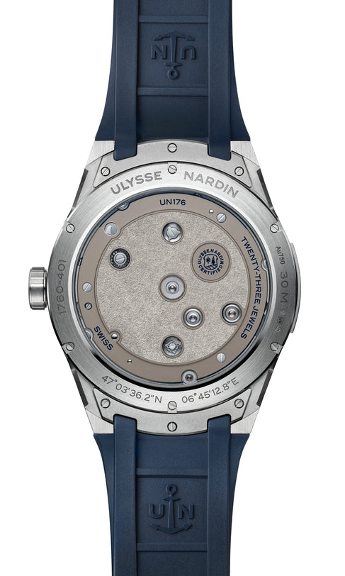Back view of the Ulysse Nardin Blast Free Wheel Maillechort watch with a blue strap, featuring exposed movement and engraved details.