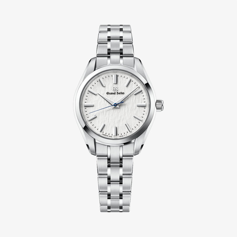 Silver watch with a white face on a light gray background