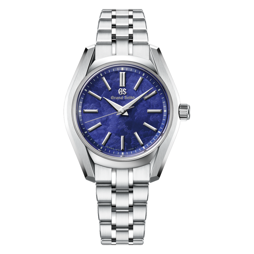 Silver stainless steel watch with blue dial, gold hour markers, and three-link metal bracelet.