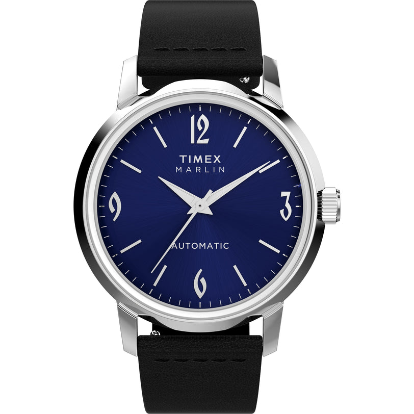 The Timex Marlin® Automatic features a blue dial, silver hour markers and hands, an eco-friendly leather strap, and "Automatic" on the face. The display shows the time as 10:09.
