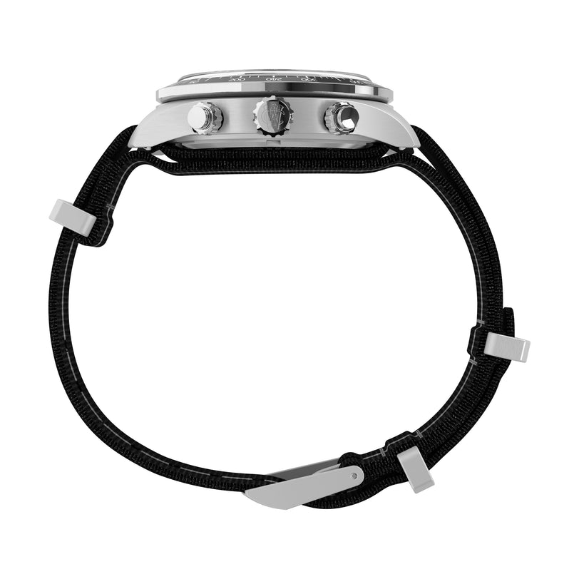 Side view of the Timex Waterbury Heritage Chronograph, showcasing its round silver case, three buttons, and black recycled fabric strap with metal buckles and loops. The watch face is not visible.