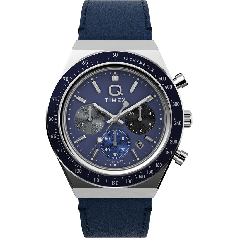 The Timex Q Chronograph features a blue and silver analog design with three subdials, a date window, tachymeter bezel, and blue leather strap—ideal for those looking for a modern racing-inspired watch.