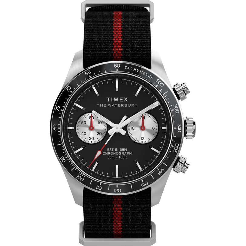 The Timex Waterbury Heritage Chronograph features a black dial with three subdials, silver accents, a recycled fabric strap with a red center stripe, and a functional tachymeter bezel for sporty style.