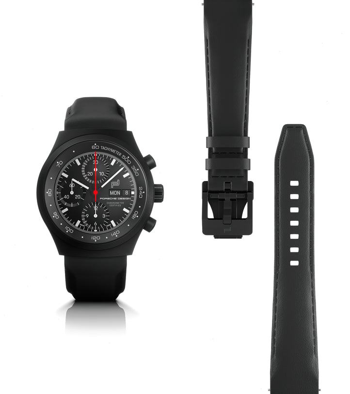 Black chronograph watch with numbered dial, red chronograph hand, and black rubber strap shown with buckle.