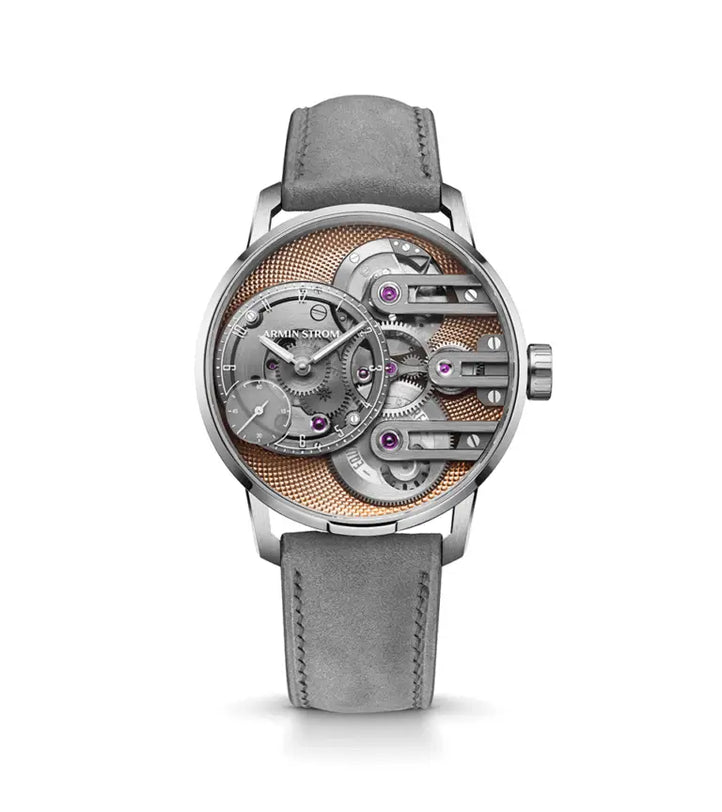 The Armin Strom Gravity Equal Force Ultimate Sapphire Salmon features a grey suede strap, open-face design with visible gears and micro rotor, purple accents, and a textured gold backdrop—combining modern style with classic elegance.