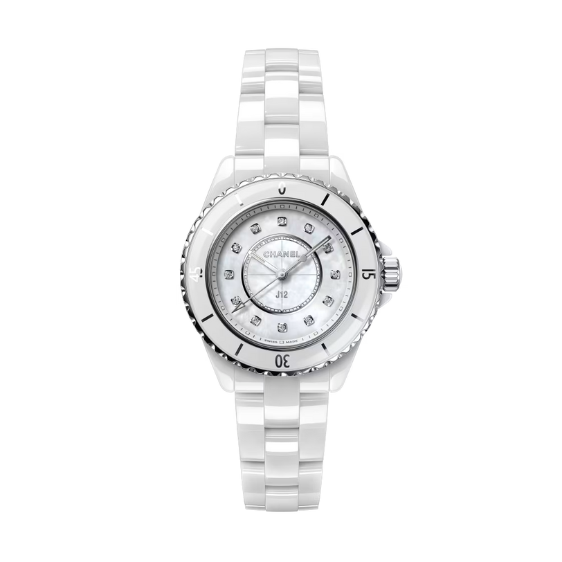 The Chanel J12 is a luxury watch with a glossy white ceramic and steel bracelet, round bezel with silver accents, and a white dial featuring diamond hour markers.