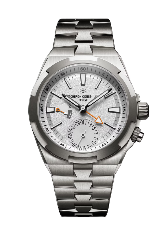 Silver stainless steel watch with white dial, dual time subdial, orange hands, and cardinal point markers.