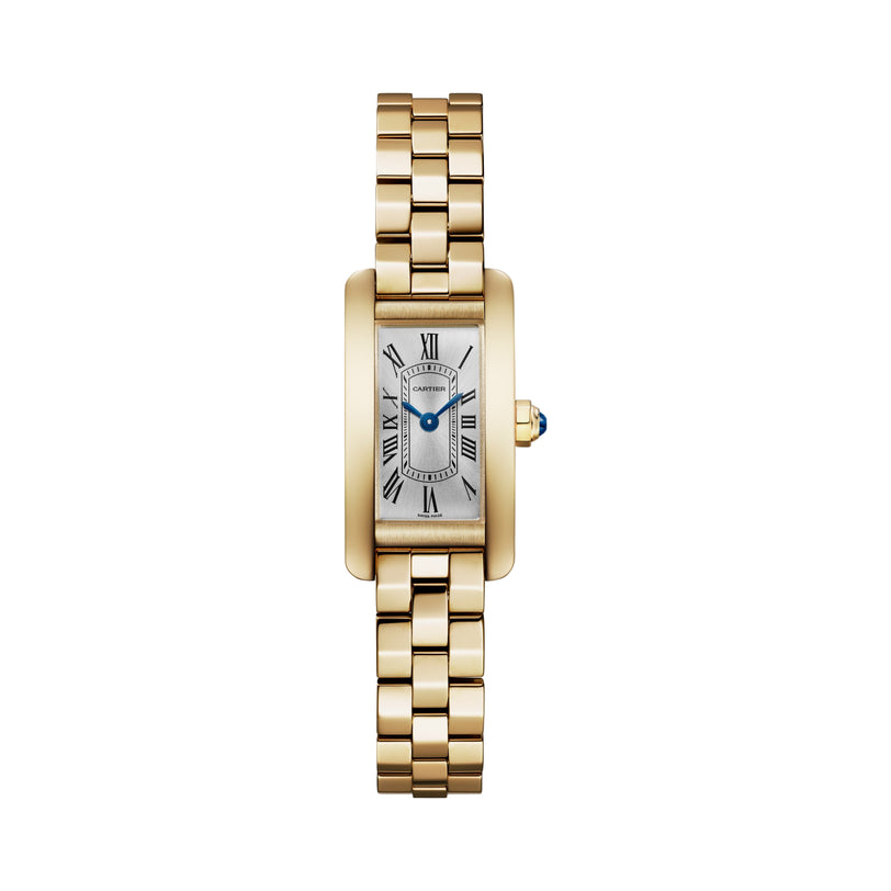 The Cartier Tank Américaine Mini Model features a rectangular 18K yellow gold case, Roman numeral dial, blue hands, linked gold bracelet, and a blue gem on the crown.