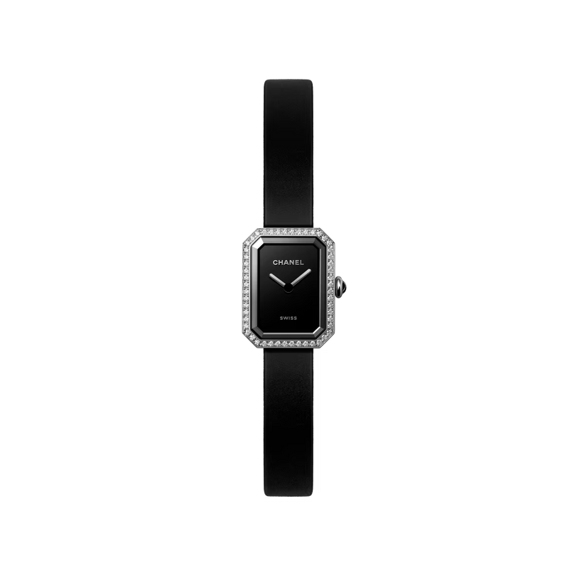 The Chanel Première Ribbon wristwatch features a rectangular black case, diamond-studded bezel, black-lacquered dial with silver hands, and a slim black leather strap, shown on a white background.