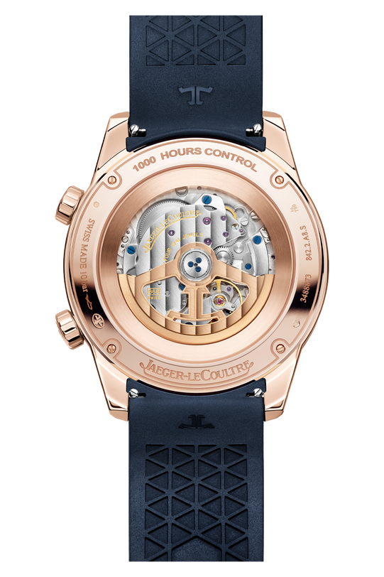 The Jaeger-LeCoultre Polaris Perpetual Calendar features a pink gold case back, visible mechanical movement, engraved branding, and a blue rubber strap with a geometric pattern.