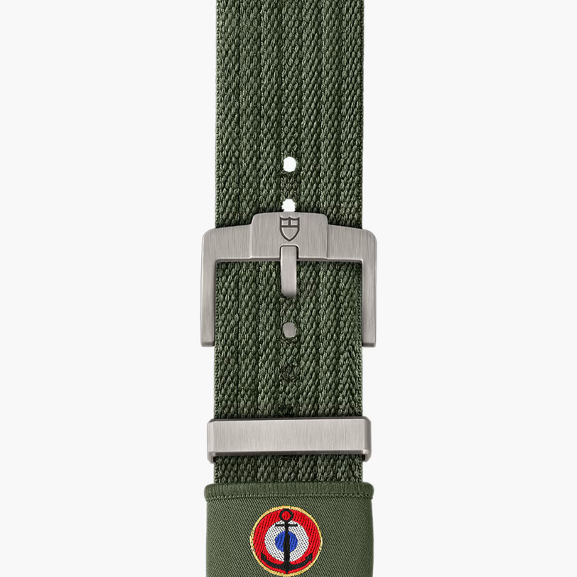 Green watch strap with silver buckle on a white background