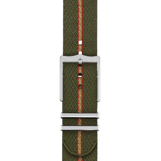 The TUDOR Ranger’s olive green fabric strap features a thin orange center stripe, silver buckle, and metal loops. Its rugged, durable texture pairs perfectly with the Ranger’s stainless steel case for an adventurous look.